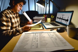 A mechanical engineer in the office goes through an inspection checklist for an oil pipeline-1-1-1